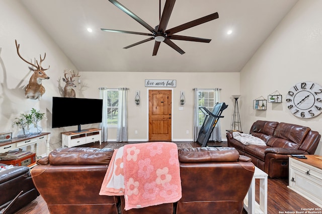 living room featuring ceiling fan, dark hardwood / wood-style floors, and vaulted ceiling