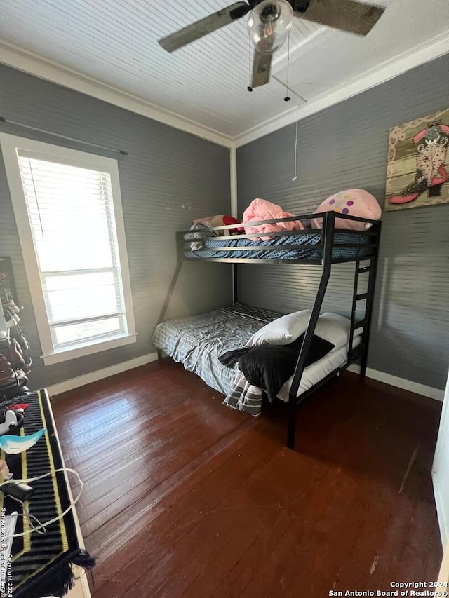 bedroom featuring ornamental molding, dark hardwood / wood-style flooring, and ceiling fan