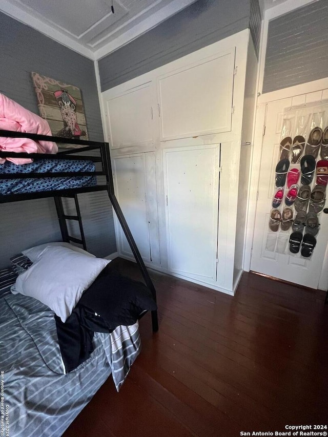 bedroom with dark wood-type flooring