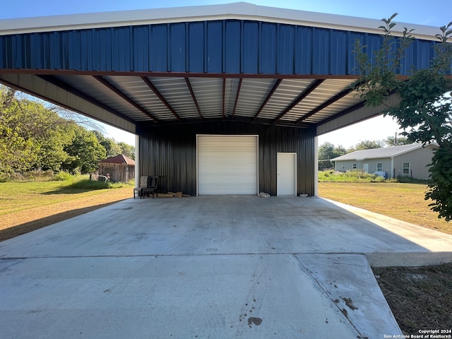 garage featuring a yard and a carport