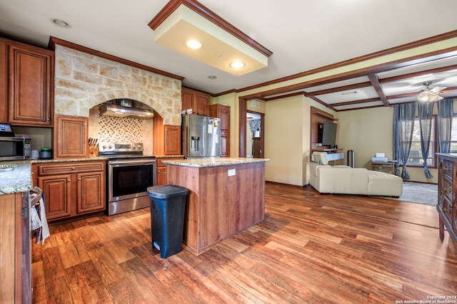 kitchen with a center island, light stone countertops, stainless steel appliances, dark wood-type flooring, and ceiling fan