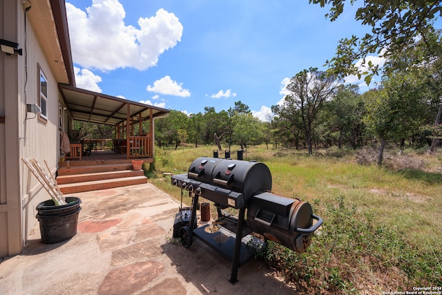 view of patio / terrace with a wooden deck and grilling area