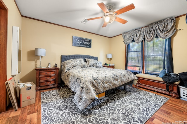 bedroom featuring ceiling fan, hardwood / wood-style flooring, and crown molding