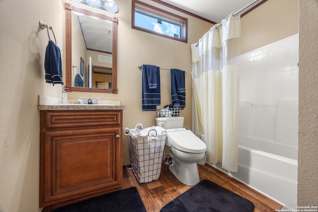 full bathroom featuring vanity, toilet, wood-type flooring, and shower / tub combo