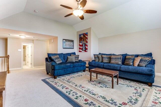 living room with lofted ceiling, ceiling fan, and light colored carpet