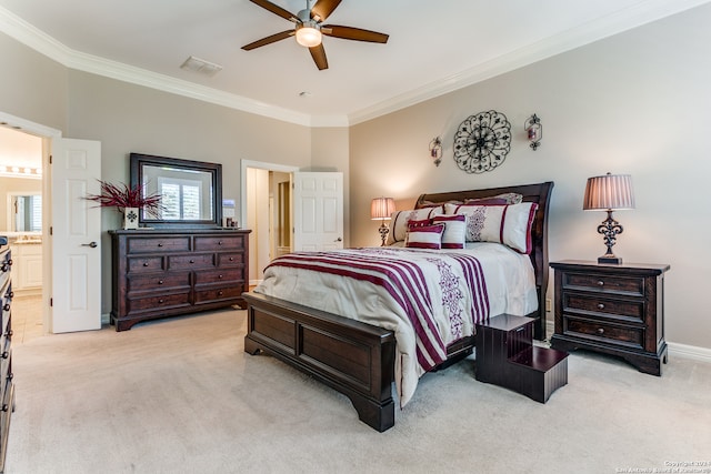 bedroom featuring ornamental molding, light colored carpet, connected bathroom, and ceiling fan