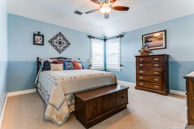 carpeted bedroom with lofted ceiling, baseboards, visible vents, and a ceiling fan