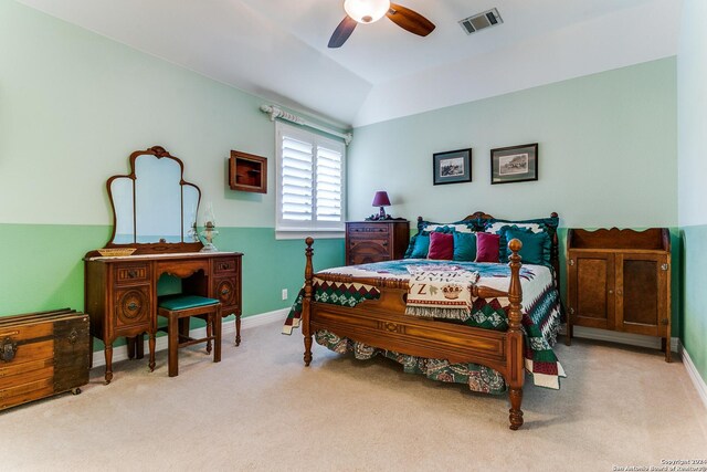 carpeted bedroom featuring lofted ceiling and ceiling fan