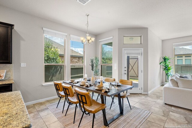 dining room with a notable chandelier, baseboards, and a healthy amount of sunlight