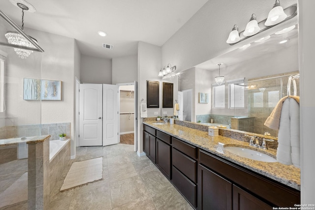 full bathroom with a shower stall, double vanity, a bath, and a sink