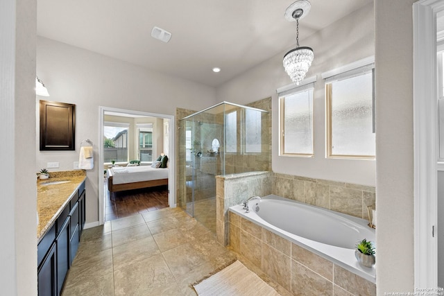 full bathroom featuring connected bathroom, a shower stall, a bath, vanity, and a notable chandelier