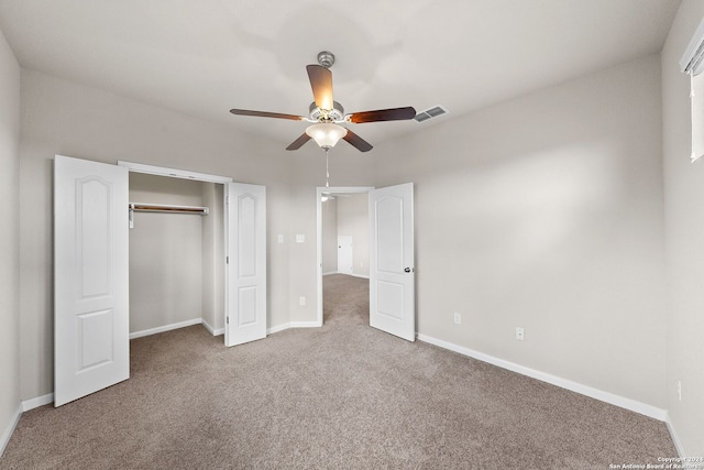unfurnished bedroom with a closet, baseboards, carpet, and visible vents