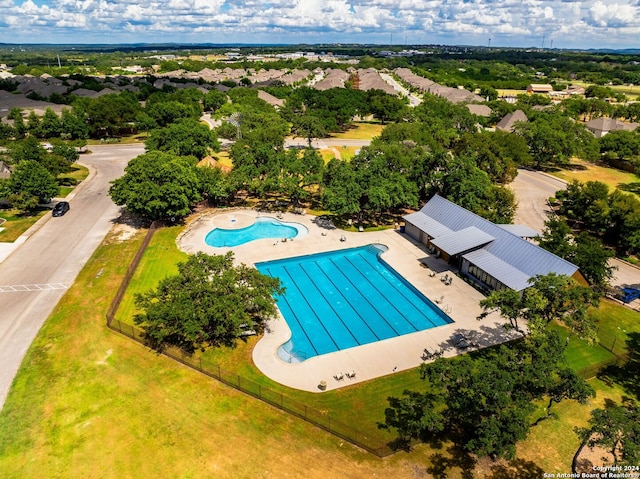 community pool featuring fence and a patio