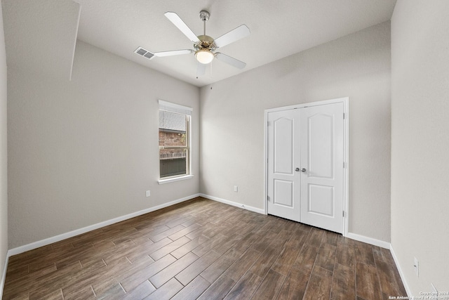 unfurnished bedroom with visible vents, baseboards, a ceiling fan, and dark wood finished floors