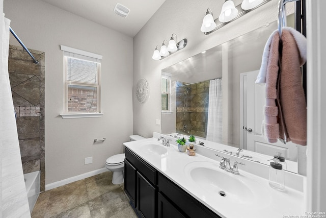 bathroom with toilet, visible vents, a sink, and baseboards