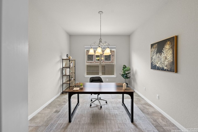 office area with a notable chandelier and baseboards