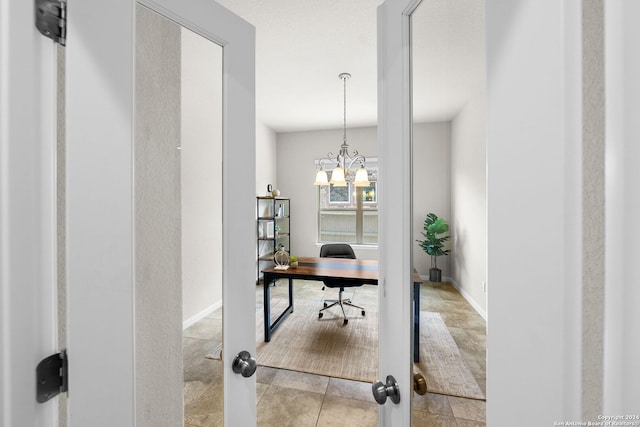 office area featuring a chandelier and baseboards