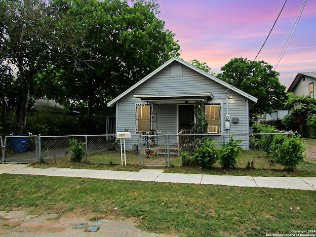 bungalow with a yard and a porch