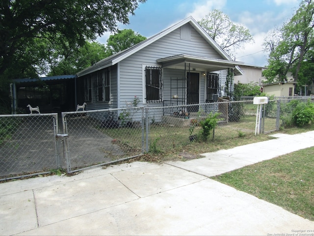 view of front of property featuring a fenced front yard and a gate