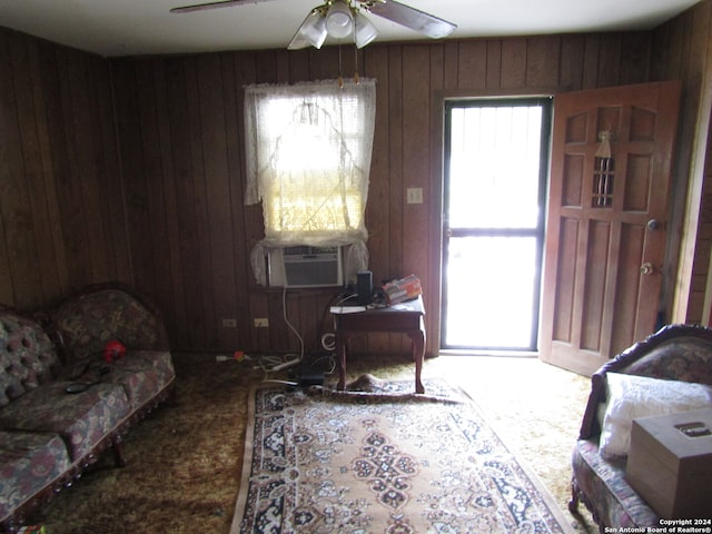 interior space featuring cooling unit, ceiling fan, and wooden walls