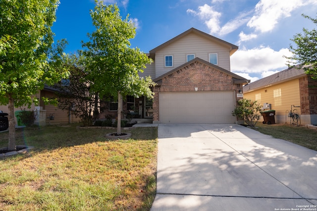 view of property with a garage and a front lawn