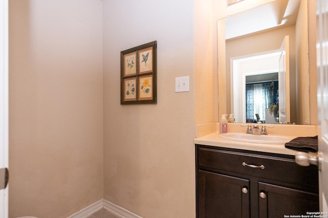 bathroom featuring baseboards and vanity