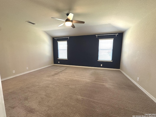 empty room featuring visible vents, plenty of natural light, and baseboards