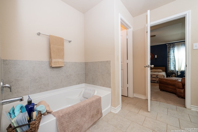 bathroom with a washtub and tile patterned floors