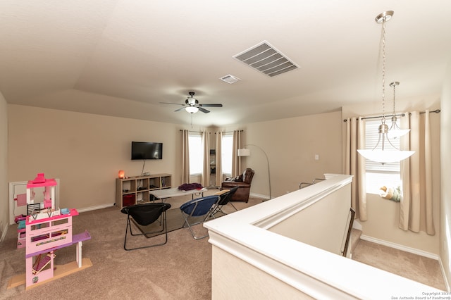 carpeted living room with plenty of natural light and ceiling fan