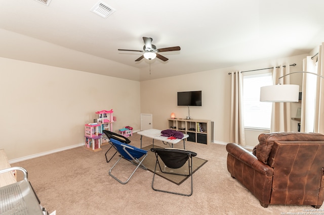 living room with light colored carpet and ceiling fan