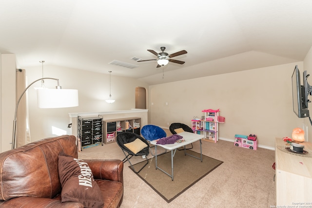 interior space with lofted ceiling, ceiling fan, and carpet flooring