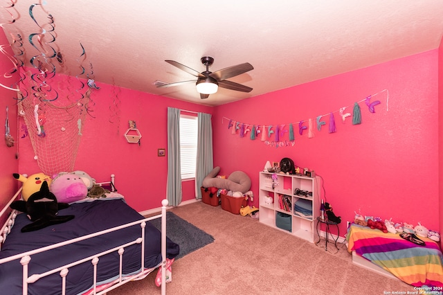 bedroom with a textured ceiling, ceiling fan, and carpet floors