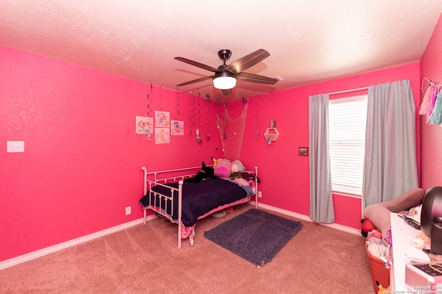 carpeted bedroom with ceiling fan and a textured ceiling