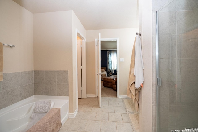 ensuite bathroom featuring tiled shower, tile patterned flooring, connected bathroom, and a bath