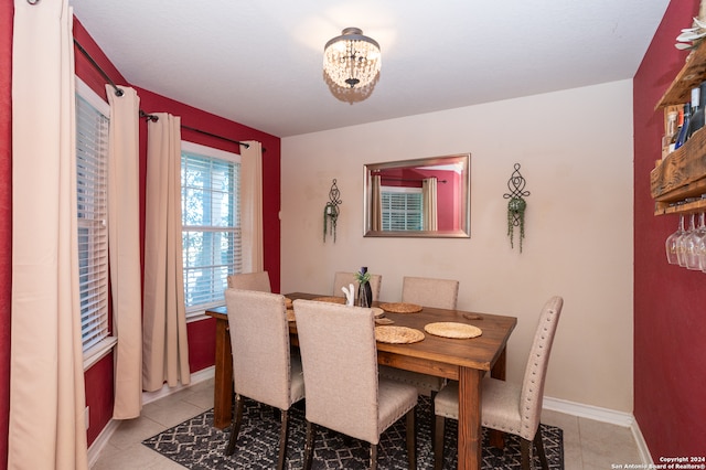 dining area with an inviting chandelier and light tile patterned flooring