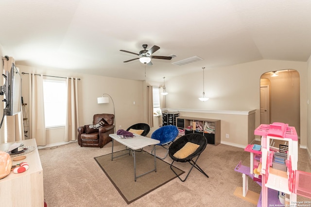 rec room featuring a ceiling fan, arched walkways, light colored carpet, and lofted ceiling