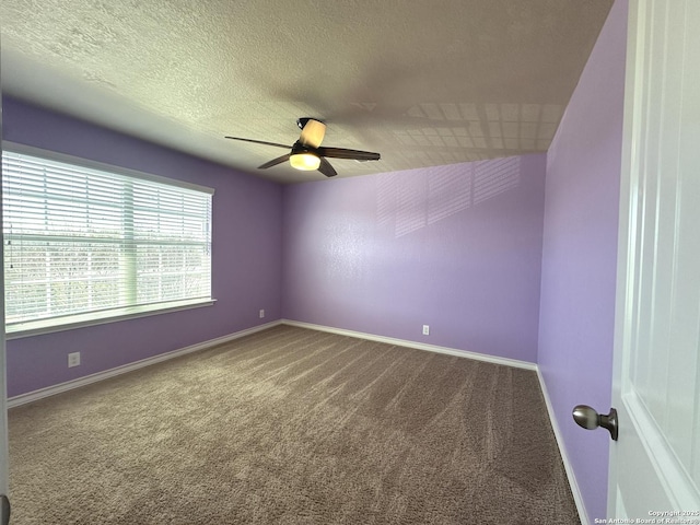 spare room with carpet, baseboards, ceiling fan, and a textured ceiling