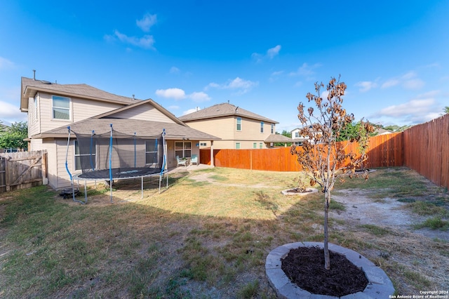 view of yard featuring a fenced backyard and a trampoline