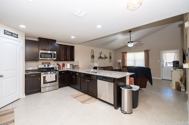 kitchen featuring appliances with stainless steel finishes, sink, lofted ceiling, kitchen peninsula, and ceiling fan