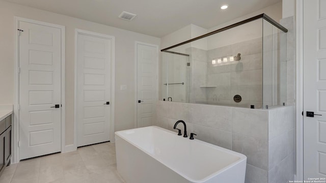 bathroom with vanity and separate shower and tub