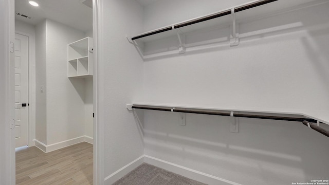 walk in closet featuring light hardwood / wood-style floors