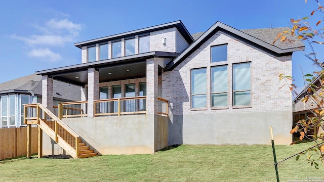 rear view of property featuring a yard