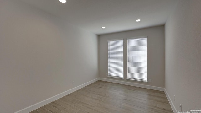 spare room featuring light wood-type flooring