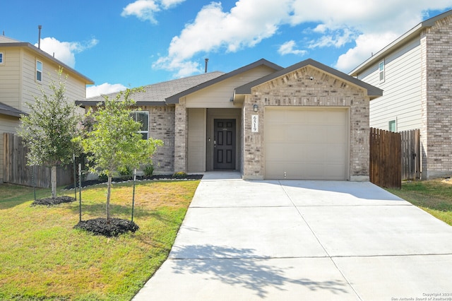 view of front of house with a garage and a front lawn