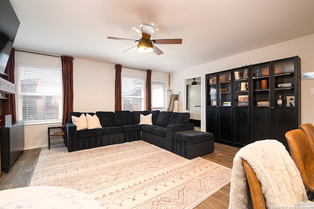 living room featuring light wood-type flooring and ceiling fan