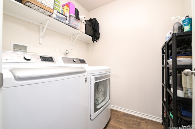 laundry room with washing machine and dryer and dark hardwood / wood-style flooring