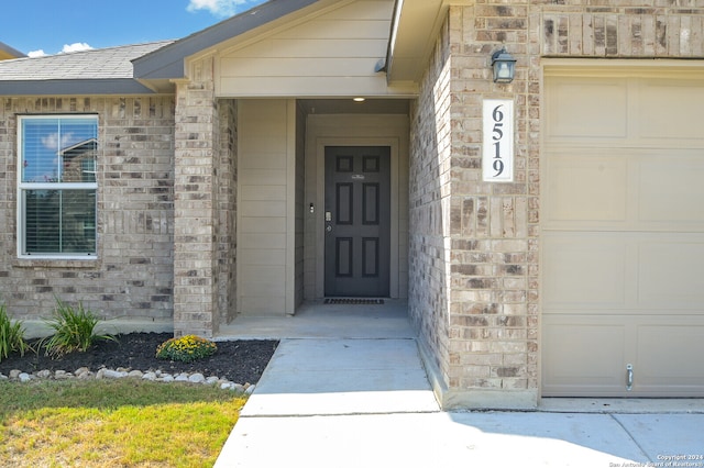 view of exterior entry with a garage