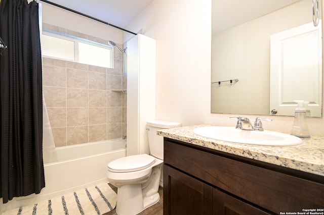 full bathroom featuring shower / bath combo with shower curtain, tile patterned flooring, toilet, and vanity