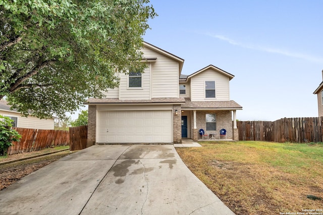 view of property featuring a front yard and a garage