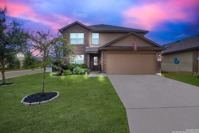 view of front of home featuring a garage and a yard